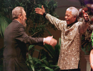 South African President Nelson Mandela (R) greets Cuban leader Fidel Castro as he arrives for the opening of the 12th Non-Aligned Movement summit in Durban on September 2, 1998. Castro resigned Tuesday as president and commander in chief of Cuba in a message published in the online version of the official daily Granma. AFP PHOTO (Photo credit should read ODD ANDERSEN/AFP/Getty Images)